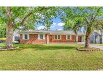 Charming brick home with a well-maintained lawn, mature trees, and inviting curb appeal at 3001 Wiley Dr., North Myrtle Beach, SC 29582