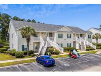 Inviting two-story condo with landscaped grounds and convenient parking at 4933 Crab Pond Ct. # 201, Myrtle Beach, SC 29579