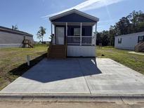 Charming single-story home with a cozy front porch and a large concrete parking area at 504 King Air Ct, Myrtle Beach, SC 29577
