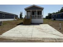 Charming home featuring a small front porch, complemented by a convenient, concrete parking area at 508 King Air Ct, Myrtle Beach, SC 29577