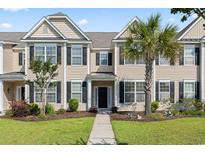Inviting two-story townhome with well-manicured lawn, palm tree, and black shutters for a classic curb appeal at 636 Pistoia Ln. # 636, Myrtle Beach, SC 29579
