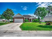 Charming brick home with a well-manicured lawn and a two-car garage on a sunny day at 638 Hatteras River Rd., Myrtle Beach, SC 29588