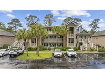 Coastal condominium exterior showcasing multiple levels with parking, landscaping, and stairway access at 69 Pinehurst Ln. # 3-F, Pawleys Island, SC 29585