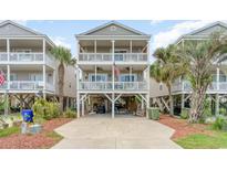 Charming three-story beach house with multiple decks and classic coastal architecture details at 712A Ocean Blvd. S, Surfside Beach, SC 29575