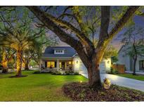 Charming home featuring a manicured lawn, mature trees, and a welcoming front porch, offering great curb appeal at 915 Palmetto St., Georgetown, SC 29440