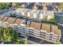 Bird's-eye view of a multi-story condo building with swimming pools and well-maintained landscaping at 9581 Shore Dr. # 127, Myrtle Beach, SC 29572