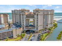 Stunning exterior view of a high-rise resort with beach access, parking, and beautiful architecture at 100 North Beach Blvd. # 515, North Myrtle Beach, SC 29582