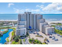 Beautiful exterior shot of a modern condo complex near the beach with ample parking and well-maintained landscaping at 101 Ocean Creek Ocean Creek Dr. # Qq3, Myrtle Beach, SC 29572