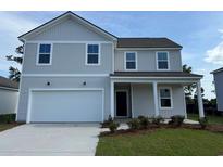Charming two-story home with neutral siding, a front-entry two-car garage, and a well-manicured lawn at 1035 Laconic Dr., Myrtle Beach, SC 29588