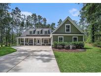 Inviting home featuring a manicured lawn, covered porch, and a concrete driveway at 109 Obd Way, Myrtle Beach, SC 29588