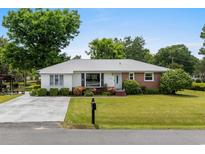 Charming single story home with a well maintained lawn and mature landscaping at 1127 Pine Dr., Myrtle Beach, SC 29577