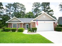 Charming single-story home featuring a brick facade, well-manicured lawn and attached two car garage at 170 Glenwood Dr., Conway, SC 29526