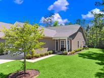 Charming single-story home with a well-manicured lawn, landscaping, and inviting entrance at 2000-D Willow Run Dr. # D, Little River, SC 29566