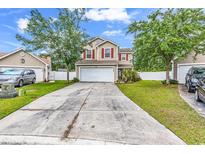 Inviting two-story home with a spacious driveway, attached garage, and well-maintained front yard at 2546 Whetstone Ln., Myrtle Beach, SC 29579