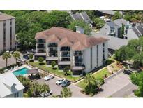 Stunning aerial view of a condo community with a pool, manicured landscaping, and ample parking at 307 74Th Ave. N # 3C, Myrtle Beach, SC 29572