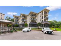 Beautiful condo building featuring multiple balconies and covered parking spaces in a coastal community at 307 74Th Ave. N # 3C, Myrtle Beach, SC 29572