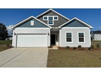 Charming single-Gathering home with a two-car garage, light siding, and beautiful architectural detail at 319 Garden Grove St, Conway, SC 29526