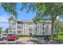 Well-maintained condo building with neatly landscaped grounds and convenient parking spaces under a clear blue sky at 351 Lake Arrowhead Rd. # 24-396, Myrtle Beach, SC 29572