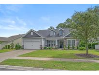 Charming single-story home features a well-manicured lawn and inviting curb appeal with stone accents at 3620 Diamond Stars Way, Little River, SC 29566