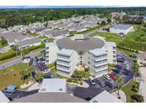 Overhead view of a condo building surrounded by lush greenery in a gated community with ample parking at 4350 Intercoastal Dr. # 2402, Little River, SC 29566
