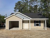 Charming single-story home featuring an attached garage and a cozy front porch at 5408 Hampton Rd., Conway, SC 29527