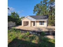 Charming one-story home with blue shutters, an attached garage, and a well-maintained lawn at 5408 Hampton Rd., Conway, SC 29527