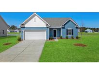 Charming blue one-story home featuring a well-manicured lawn and attached two-car garage at 622 Castillo Dr., Loris, SC 29569