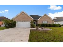 Charming single-story brick home featuring an attached two-car garage and manicured landscaping at 728 Churchill Dr., Myrtle Beach, SC 29579