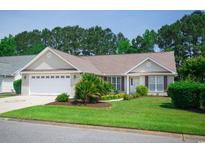 Charming single-story home featuring a well-manicured lawn and an attached two-car garage at 1044 Vestry Dr., Murrells Inlet, SC 29576