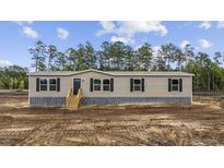 Charming single-story home with a gray stone foundation and black shutters at 1300 Rabbit Ln., Conway, SC 29526
