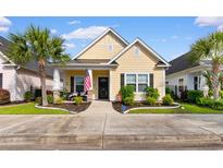 Charming yellow home featuring a well-manicured lawn and an inviting front porch at 1404 Riverport Dr., Conway, SC 29526