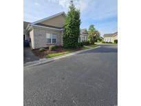 Charming brick home with a well-maintained lawn and mature landscaping at 1426 Saint Thomas Circle # A 3, Myrtle Beach, SC 29577