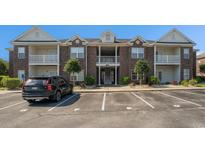 A charming brick condo building features upper and lower balconies in a landscaped community at 2029 Silvercrest Dr. # 22B, Myrtle Beach, SC 29579