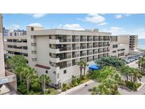 Beautiful exterior view of a multi-story building featuring balconies, palm trees, and manicured landscaping at 208 74Th Ave. N # 2-417, Myrtle Beach, SC 29572