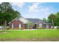 Inviting one-story brick home with a well-manicured lawn and mature landscaping at 249 Ashepoo Creek Dr., Myrtle Beach, SC 29579