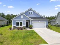 Charming single-story home with blue siding, well-manicured lawn, and a two-car attached garage at 3021 Sistine St., Myrtle Beach, SC 29579