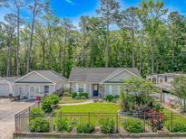 Charming home with manicured lawn, garden, and mature trees in a tranquil neighborhood at 3827 El Duce Pl., Myrtle Beach, SC 29588