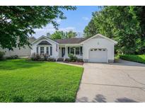 Charming single-story home with a well-maintained lawn, driveway, and attached garage at 4311 Bradford Circle, Myrtle Beach, SC 29588