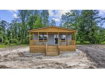 Charming home featuring a welcoming wooden porch and a well-lit exterior at 491 N Green Sea Rd., Loris, SC 29569