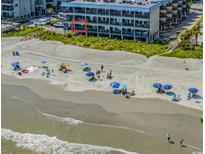 Aerial shot showcases a condo building with a beautiful beach and ocean view at 6000 N Ocean Blvd. # 119, North Myrtle Beach, SC 29582