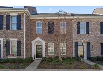 Charming brick townhome with black shutters, neat landscaping, and inviting front entrance at 750 Howard Ave. # C, Myrtle Beach, SC 29577