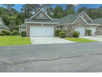 Charming townhome featuring a two-car garage, well-maintained landscaping, and inviting curb appeal in a desirable community at 750 Pinehurst Ln. # 84A, Pawleys Island, SC 29585