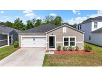 Charming single-story home featuring a one-car garage, neutral siding, and a well-maintained landscaped front yard at 751 Dusty Pine Way, Myrtle Beach, SC 29588