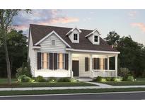 Charming one-story home featuring a welcoming front porch and meticulously landscaped front yard at 905 Monmouth Dr., Myrtle Beach, SC 29588