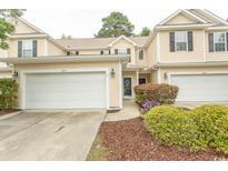 Charming townhome with a two-car garage, manicured landscaping, and inviting curb appeal at 1028 Fairway Ln. # 71, Conway, SC 29526