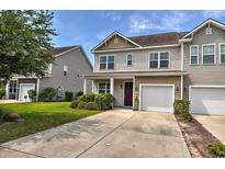 Charming two-story home with a one car garage, landscaped front yard, and covered front porch at 1029 Tee Shot Dr. # 1029, Conway, SC 29526