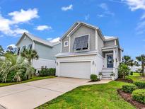 Charming two-story home with a well-manicured lawn, garage, and attractive curb appeal at 104 Splendor Circle, Murrells Inlet, SC 29576