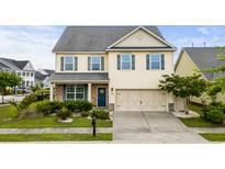 Charming two-story home with landscaped front yard, a two car garage and welcoming blue front door at 1189 Wyatt Ln., Myrtle Beach, SC 29577