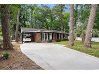 Charming brick ranch home with a long driveway and attached carport at 1205 King St., Myrtle Beach, SC 29577