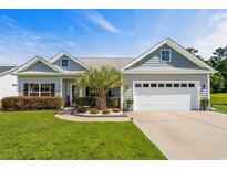 Charming single-story home with a well-manicured lawn, a two-car garage and nice landscaping at 142 Grier Crossing Dr., Conway, SC 29526